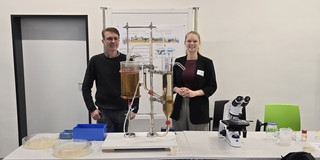 Jörg Fischer and Ronja Weidemann behind the model wastewater treatment plant at the stand in the BCI-Galerie